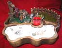 Cottage styled fountain with water wheel, rock garden and candle holder sold wholesale by online collectible craft import exchange company